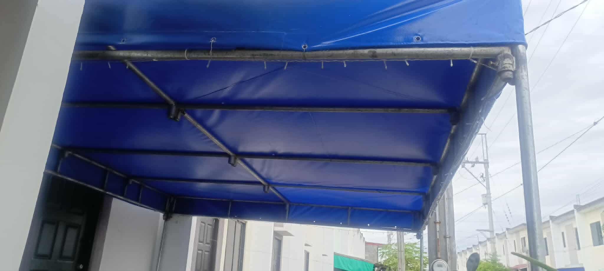 Blue tarpulin canopy installed outdoors